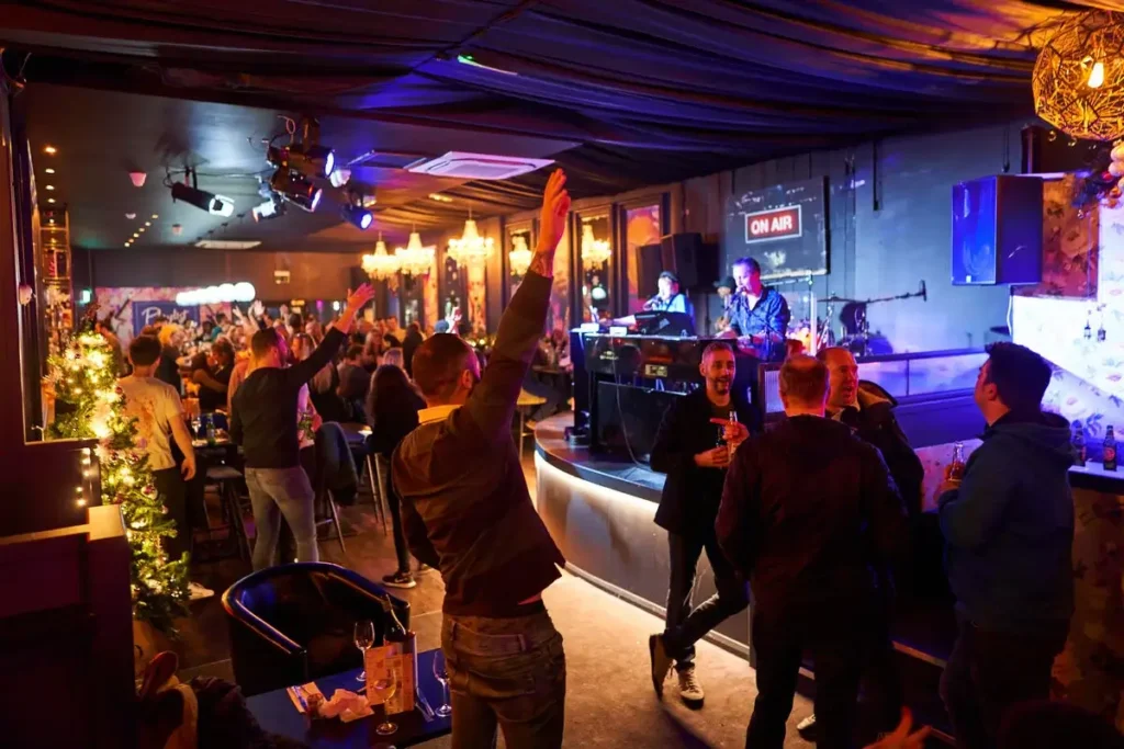 Festive crowd enjoying Christmas Party Nights at Playlist Live in Reading with live music and vibrant atmosphere
